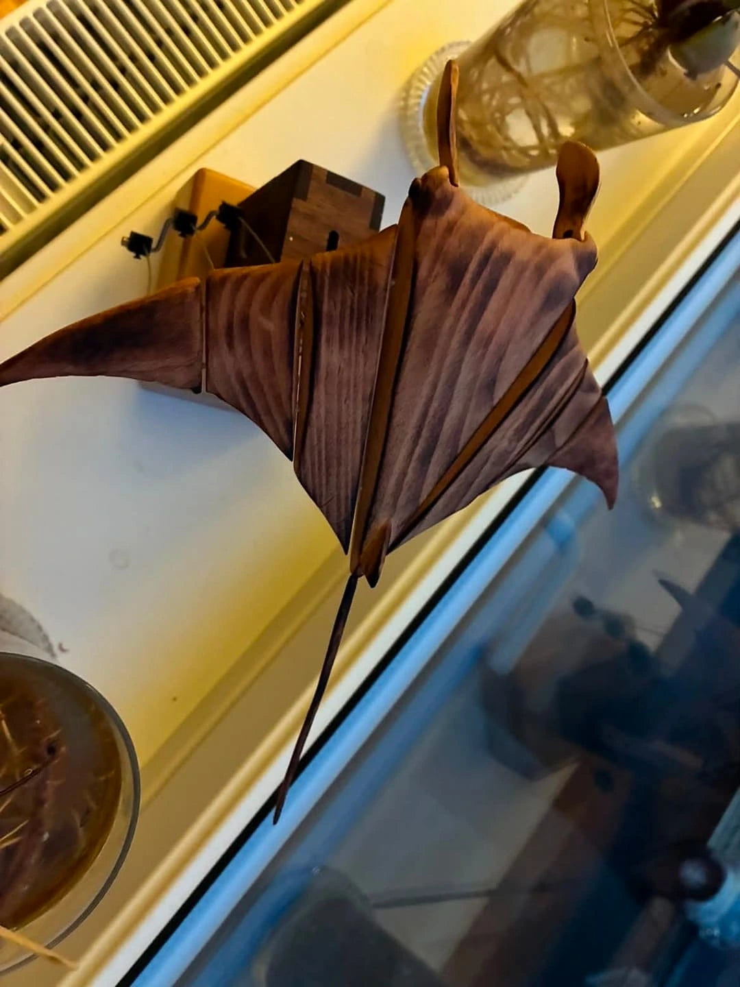 Wooden manta ray on a windowsill